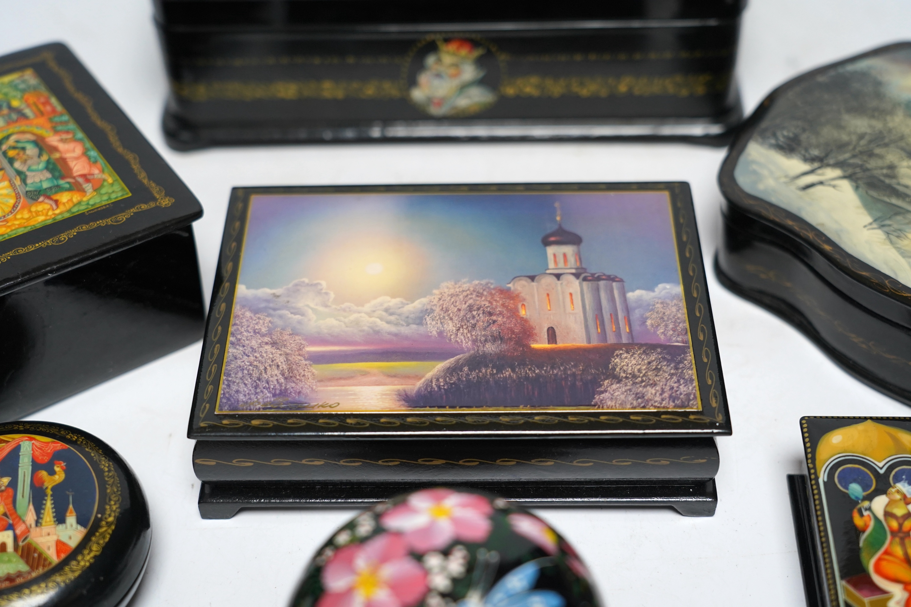 Seven Russian lacquer boxes, largest 21.5cm wide. Condition - fair to good